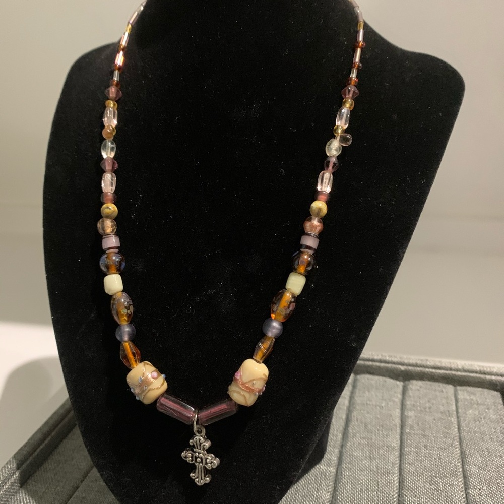 Cross necklace with painted floral beaded chain.